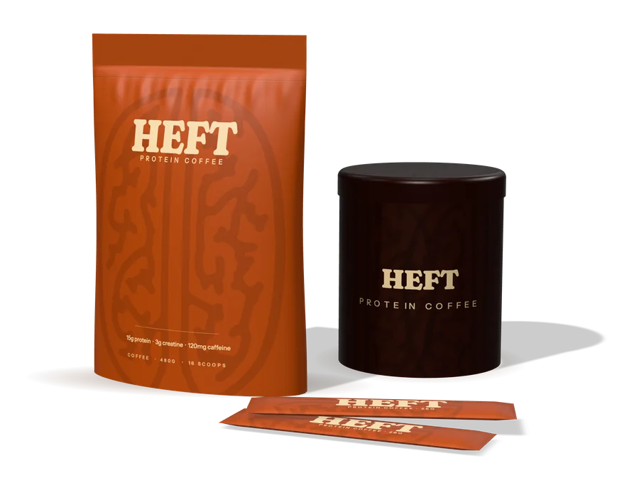 A rust-coloured HEFT pouch beside a dark HEFT tin and two single-serve sticks.